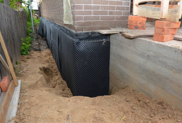 SJ Waterproofing Pros technician performing targeted Wet Basement Repair assessment in Greenlawn, NY